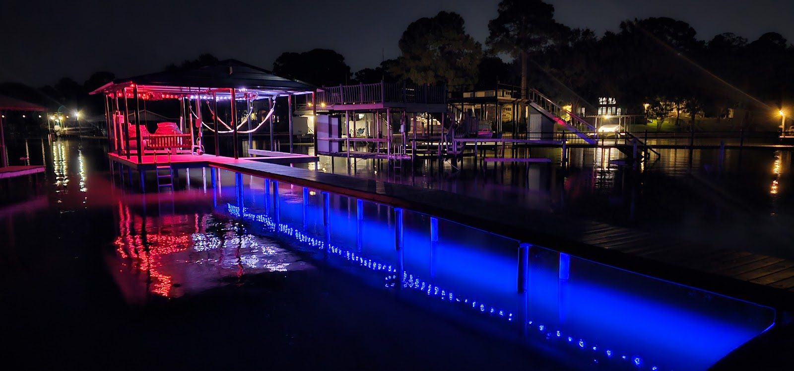 Cove of docks lit in color at night