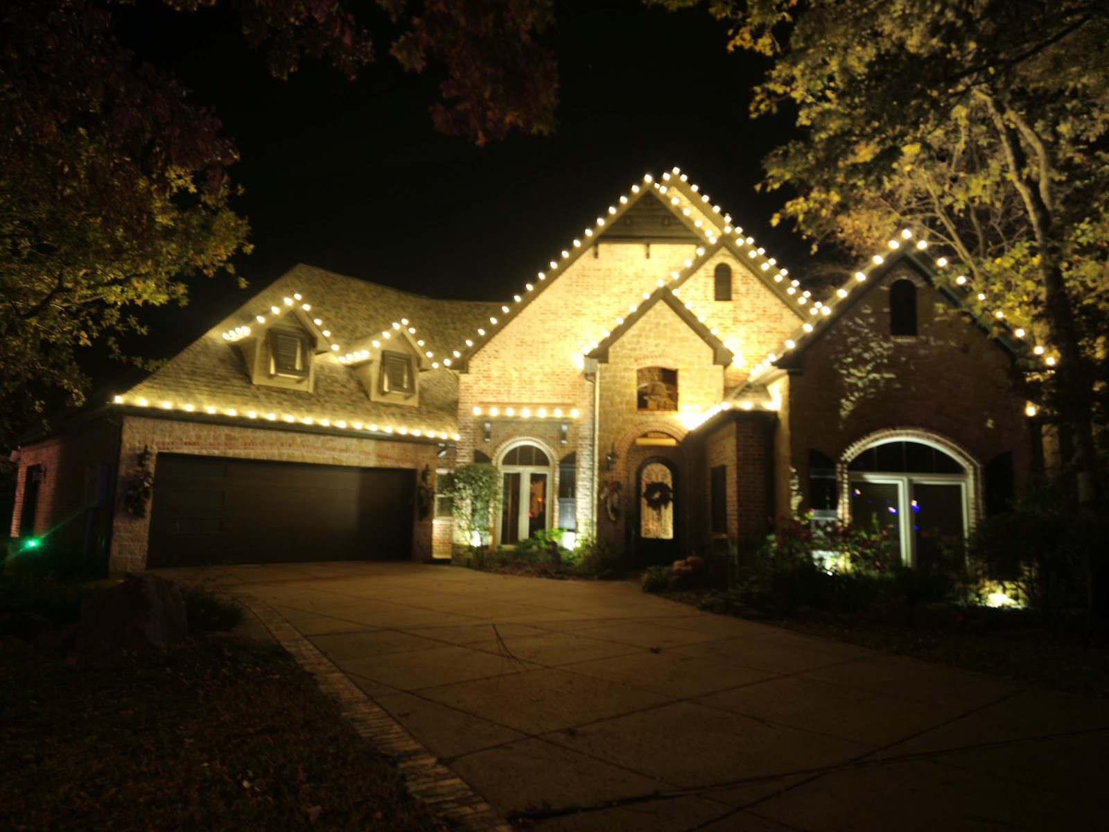 Brick home outlined in warm white lights
