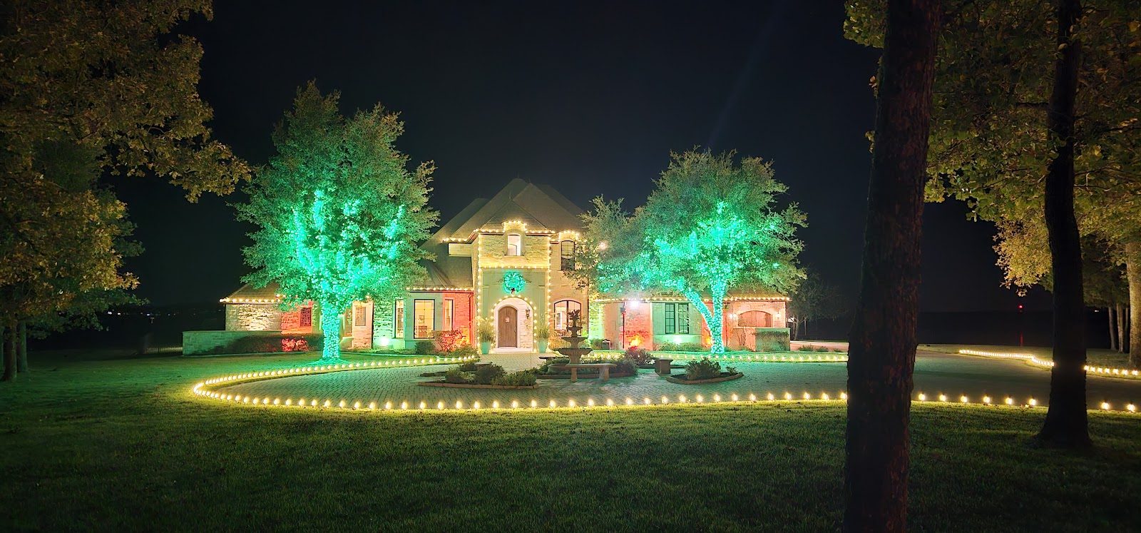Home and trees lit green and red